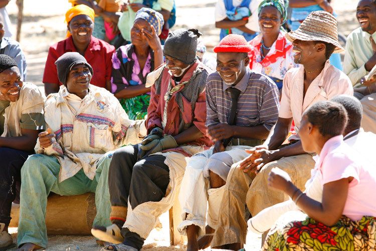 Members of The Bulala Community Youth Group perform a play about the dangers of HIV/AIDS. They dress in ragged clothes and paint their faces to portray older members of their village and the importance of changing attitudes towards the disease. Bulala, Malawi. 1malweb2012_011.jpg