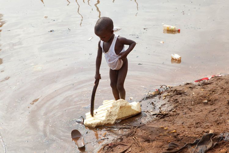 A Child plays in the Estuary of Kroo Bay Slum. There are no working toilets in Kroo bay and the Estuary serves the local population for all washing and sanitation needs. Sierra Leone for VSO. 1sierra_leone_kroobay_2.jpg