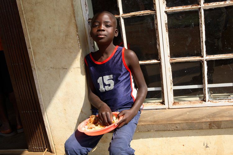 Willy phiri, 11 years old enjoys a free meal at The Chisomo drop n centre for street children. Willy has just spent 1 month in Juvenile detention for Robbery. His mother is HIV+, unwell and Willy and his older sister often spend time on the streets sleeping rough and looking for food. lilongwe, Malawi. 1malawi_street_child_4.jpg