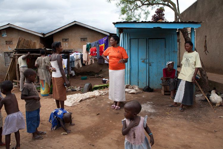 Bwaise Tusitukirewamu Womens Group. 'Tusitukirewamu' means 'United we Stand'. Members of the group walk the streets and alleys of Bwaise in Orange T shirts, trying to reach out to other women who may need help and support. Kampala, Uganda. 1uganda_sex_worker_25.jpg