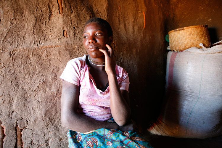 Ivy, 16 years old, in the grain store she also uses as a bedroom. Ivy has had to leave school to support her three younger siblings, as both parents and stepmother all died of HIV/AIDS. Ivys youngest brother also has HIV. Bulala, Malawi. 1malawi_hiv_orphan_ivy.jpg