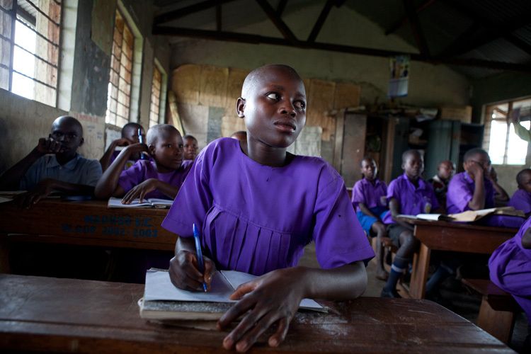 Justine Nyirantungane 15 years old during lessons at Kitemba primary school. Girls often miss weeks at a time of their education due to parents taking them out of school to help with farming. Boys' education is prioritised and their studies usually remain uninterrupted . This can result in teenage females repeatedly trying to pass end of year exams in order to progress to secondary school. Mubende, Uganda for ActionAid. 1uganda_education_7.jpg