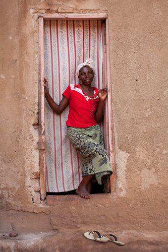 Hajara 20 yrs, commercial sex worker, in the doorway of her home,  Bwaise slum, Kampala, Uganda. 1uganda_sex_worker_23.jpg