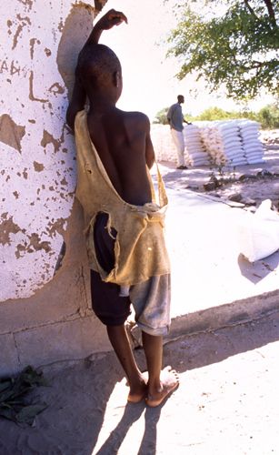 A young boy looks at the recent arrival of food from the World Food programme. Save The Children, Zimbabwe. 1zimbabwe_child_food_1.jpg