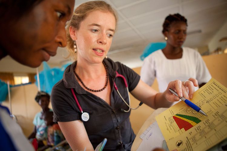 Natasha Sauven, Paediatrician and VSO volunteer at Makeni Government Hospital teaches 2nd year nursing student Agnes Ksesay how to read the infant health card and recognise potential health risks. Makeni Government Hospital, Sierra Leone. 1sierra_leone_medicine_hospital.jpg