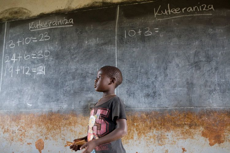 Sarah, 7 years old at the blackboard of Katasenywa Primary School Sarahs mother can not afford school uniform, without Uniform students cannot attend school. Sarah is behind in her studies. Masindi, Uganda. 1uganda_education_8.jpg