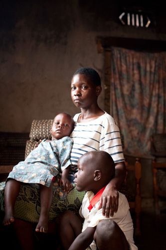 HIV+ Rosette Namukasa, 24 yrs with her daughter Vivian 3yrs and son Kevin 7yrs at their home in Bwaise Slum. Kampala, Uganda. 1uganda_sex_worker_hiv_22.jpg