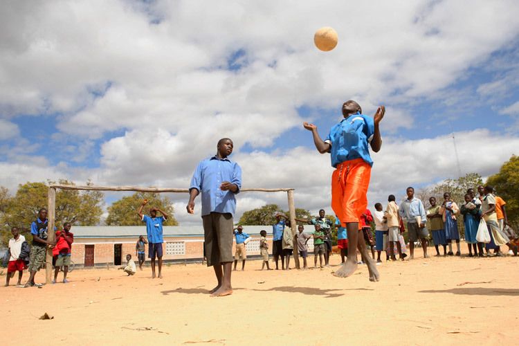 Dongo,15 years playing football with schoolfriends. Dongo cares for his 11 year old sister and 15 year old brother. His mother is dead and his father is in jail for stealing cattle. It is only with the support the Bulala youth group has given him that he is still able to attend school. Bulala, Malawi. 1child_malawi_hiv_aids_orphan.jpg