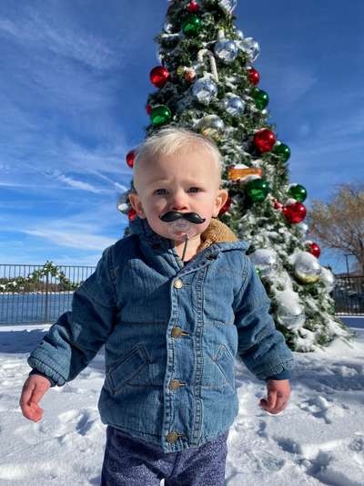 Kid by Christmas Tree