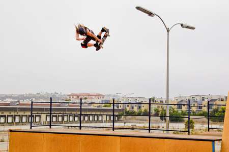 Shaun White flies above a vert ramp on his skateboard in Marina Del Ray California. He has perfect style and is doing a method air. Shaun White flies above a ramp on his skateboard