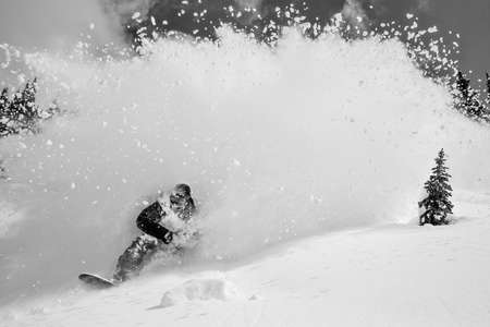 Frankie Chapin. Baldface, BC. Canada. Riding through epic powder with it flying through the air. Snowboarder Flys Out of an Explosion of Powder