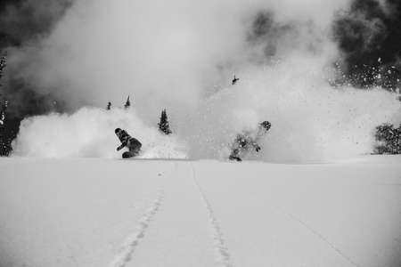 Kelly Clark. Kimmi Fasani. Baldface, BC. Tandem powder turns in pristine backcountry conditions. Snowboarders slash powder side by side