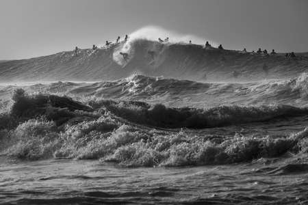 Surfers. Pipeline. Oahu, HI on the Northshore 2 surfers drop into a massive waves at Pipeline