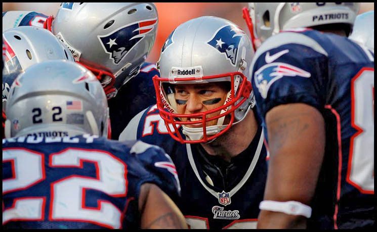 New England Patriots quarterback TOM BRADY shows his intensity in the huddle.