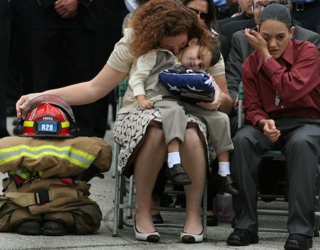 Fallen firefighter's wife and children grieve during his memorial service.