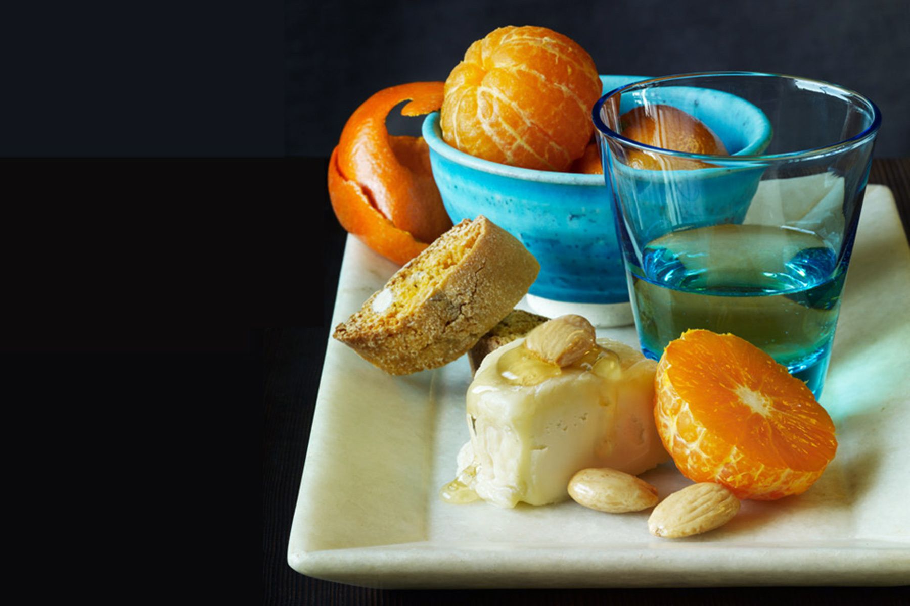 Fresh oranges with bread and cheese