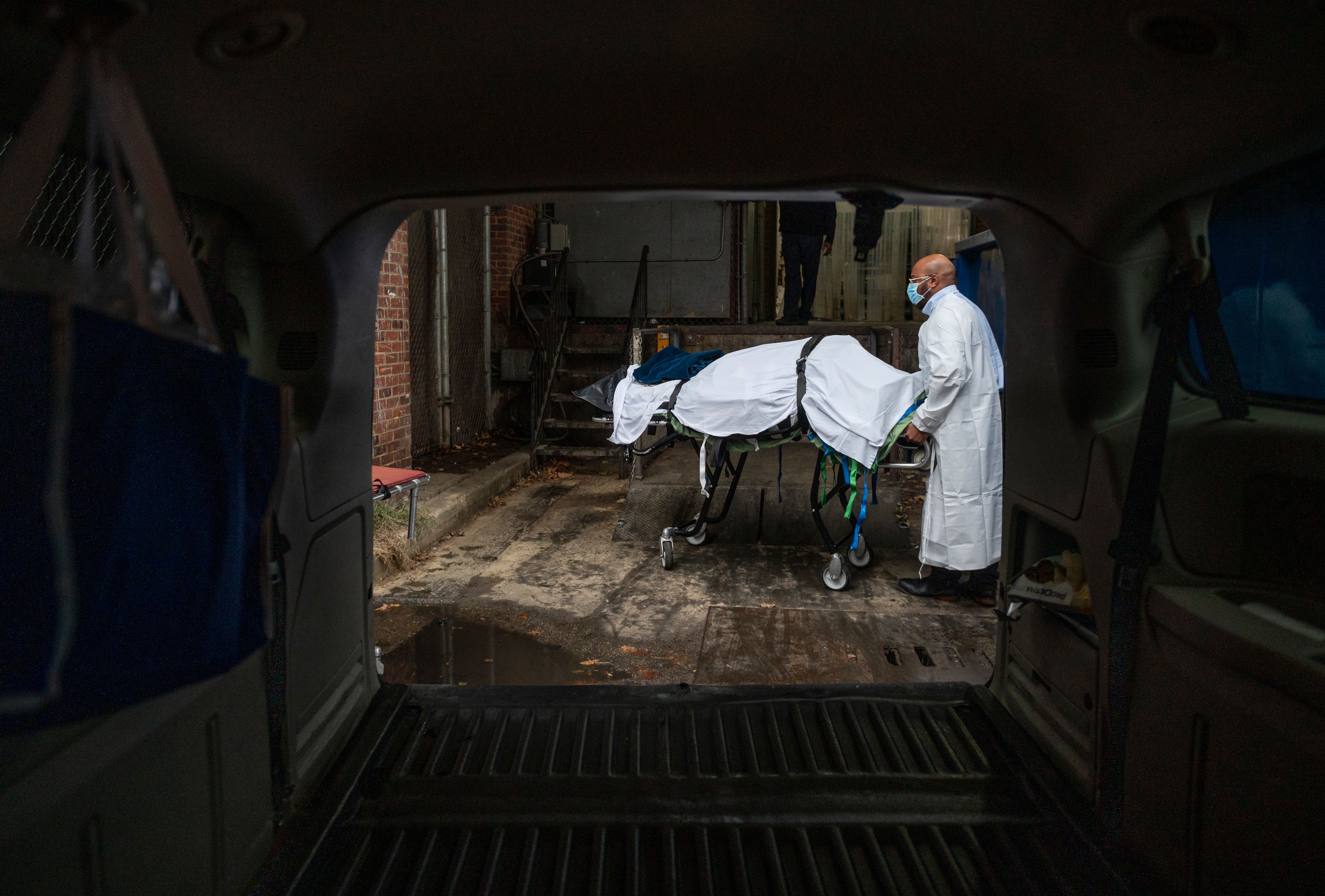 Maryland Cremation Services transporter Reggie Elliott brings the remains of a Covid-19 victim to his van from the hospital's morgue in Baltimore. 8XQ7A7.jpg