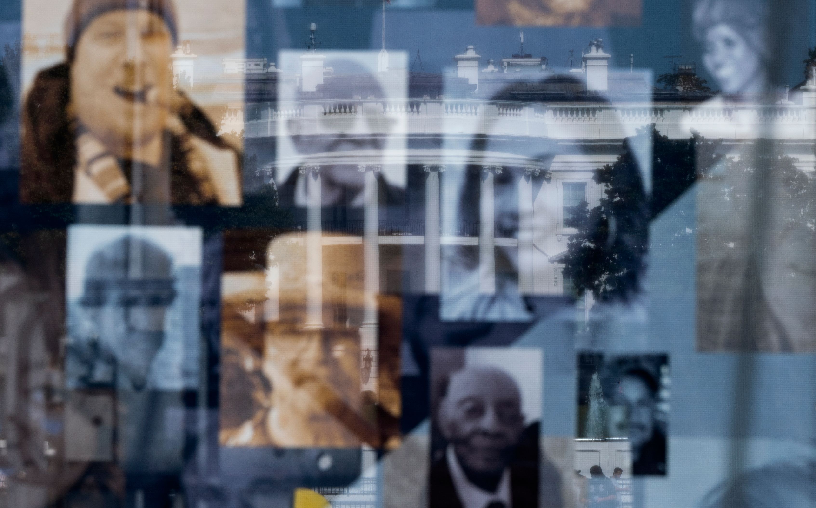 The White House is seen through pictures of people that died due to COVID-19 at the National COVID-19 Remembrance, on the ellipse behind the White House . 8RE9CE.jpg