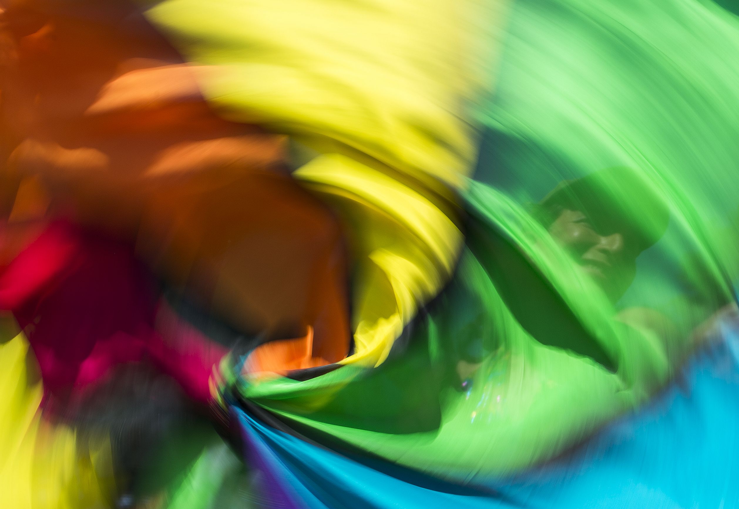 A woman spins rainbow flags as she takes part in the Equality March for Unity & Pride parade in Washington DC, June 11, 2017.