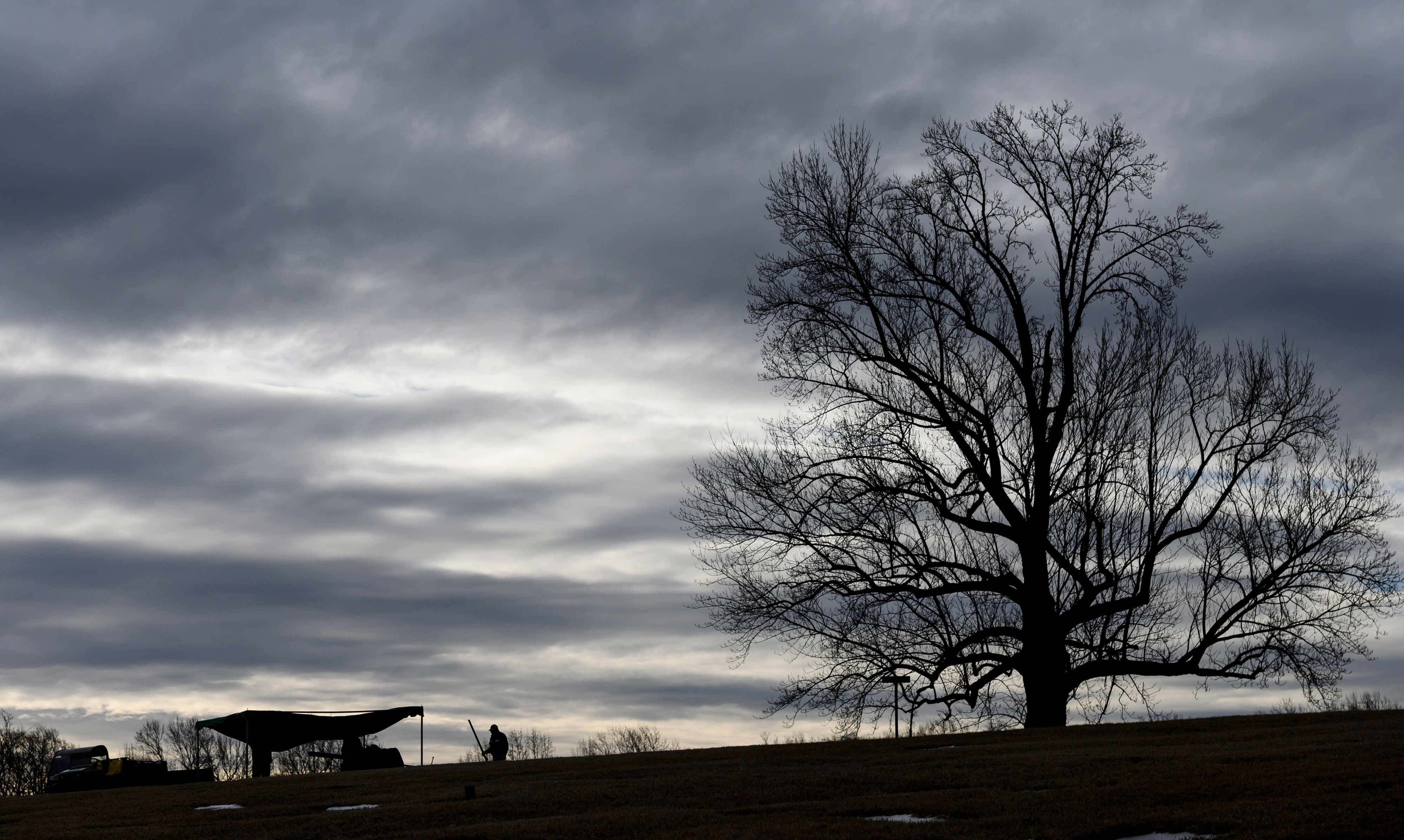 Cemetery workers prepare a grave early in the morning at a cemetery in Hyattsville. 93M43Q.jpg