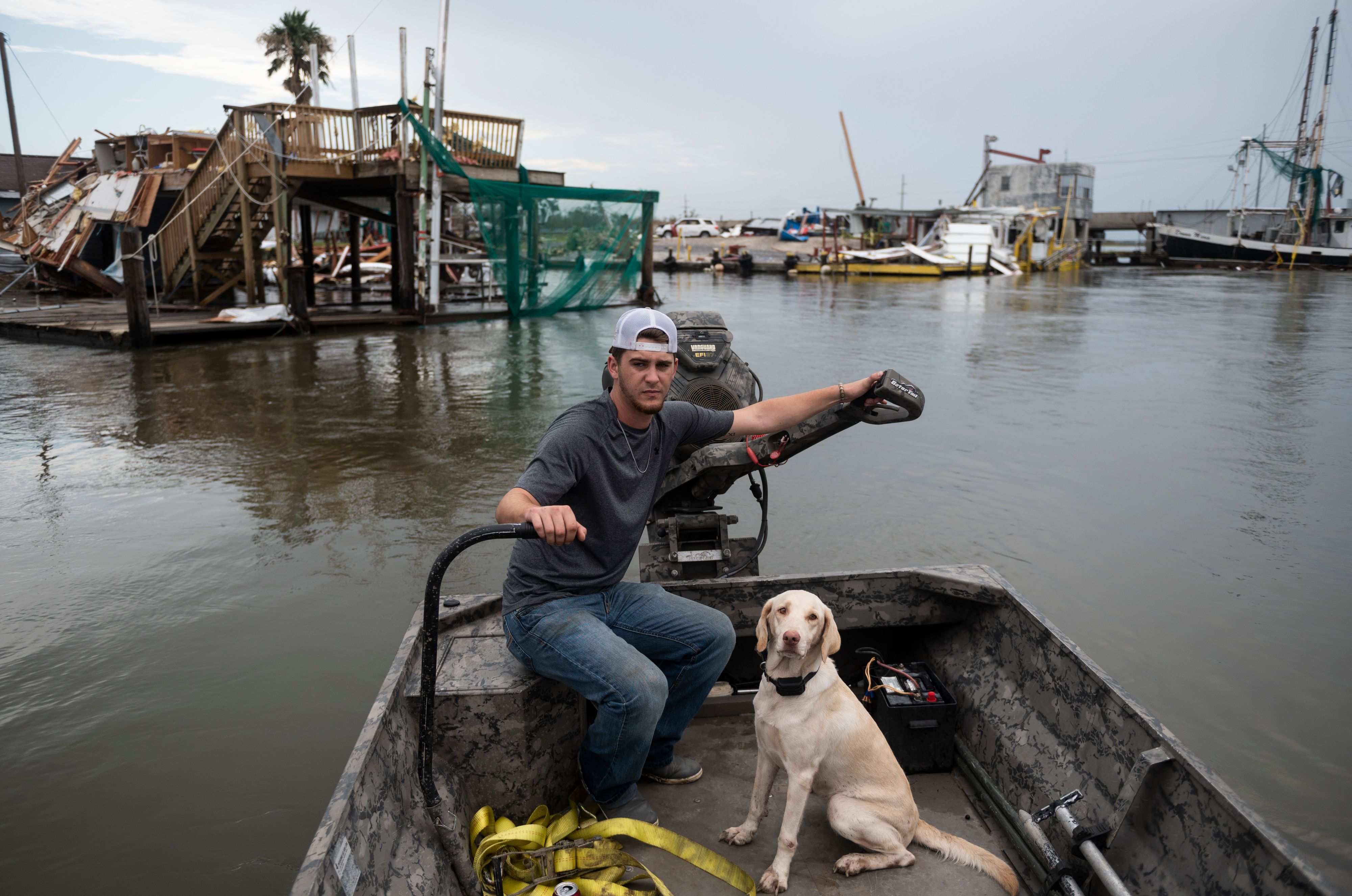 Blacen Dronet navigates his boat past destroyed buildings damaged by hurricane Laura as he surveys the damage in Hackberry, Louisiana on August 28, 2020. 1WU2FU.jpg
