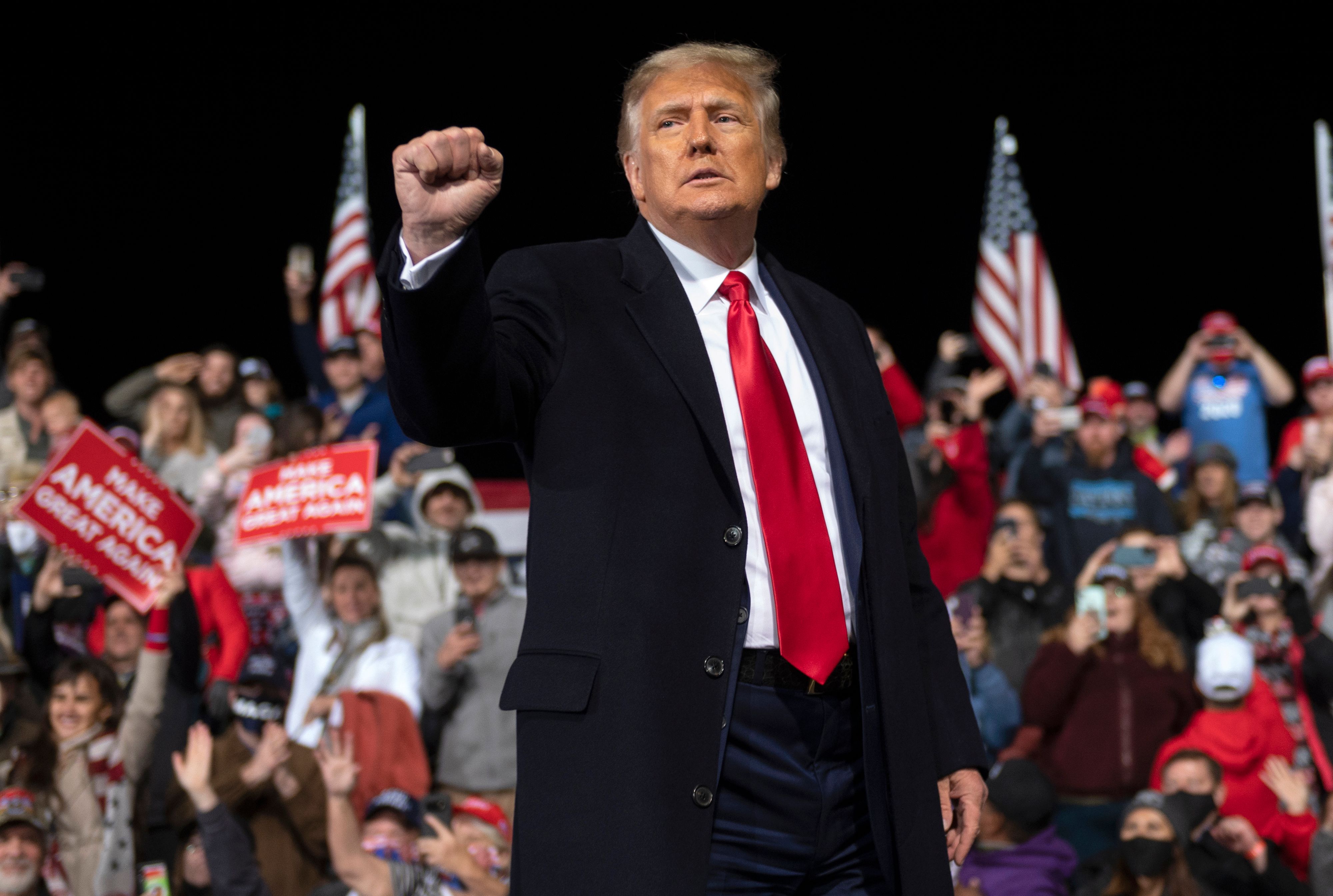 US President Donald Trump holds up his fist as he leaves the stage at the end of a rally to support Republican Senate candidates at Valdosta Regional Airport in Valdosta, Georgia. 8WK48P.jpg