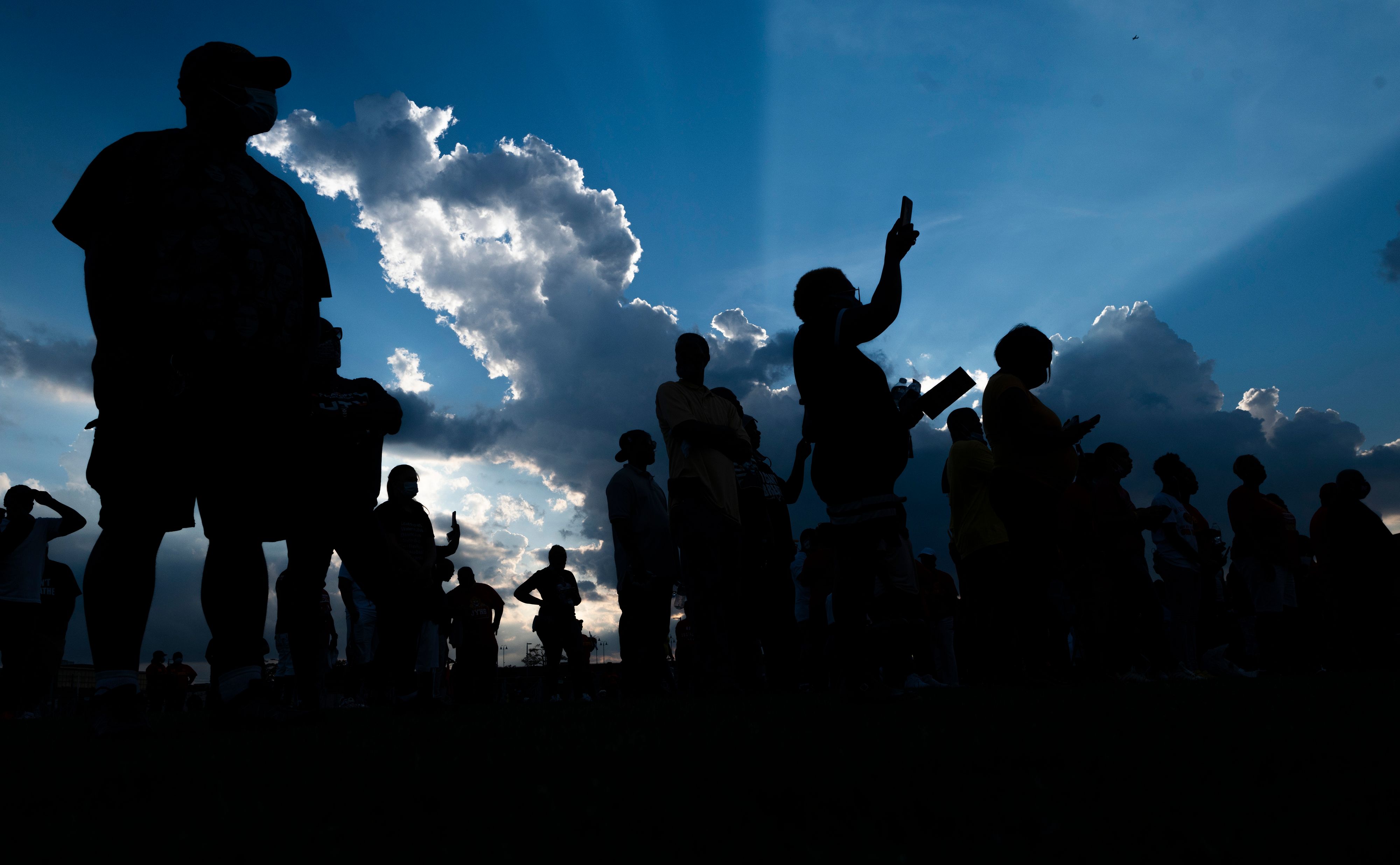 Visitors pay their respects to George Floyd during a candlelight vigil at Jack Yates High School 1T434E.jpg
