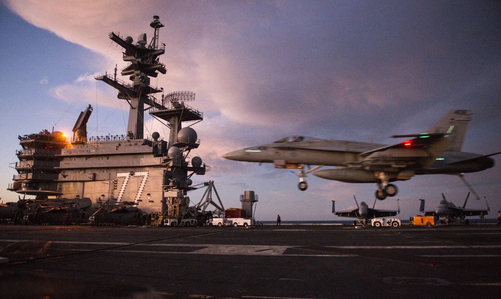an F/A-18 Hornet lands during late evening operations on the USS George H.W. Bush aircraft carrier in the Atlantic ocean on October 25, 2017, as the carrier strike group takes part in Operation Bold Alligator, a multinational warfare exercise hosted by the United States.