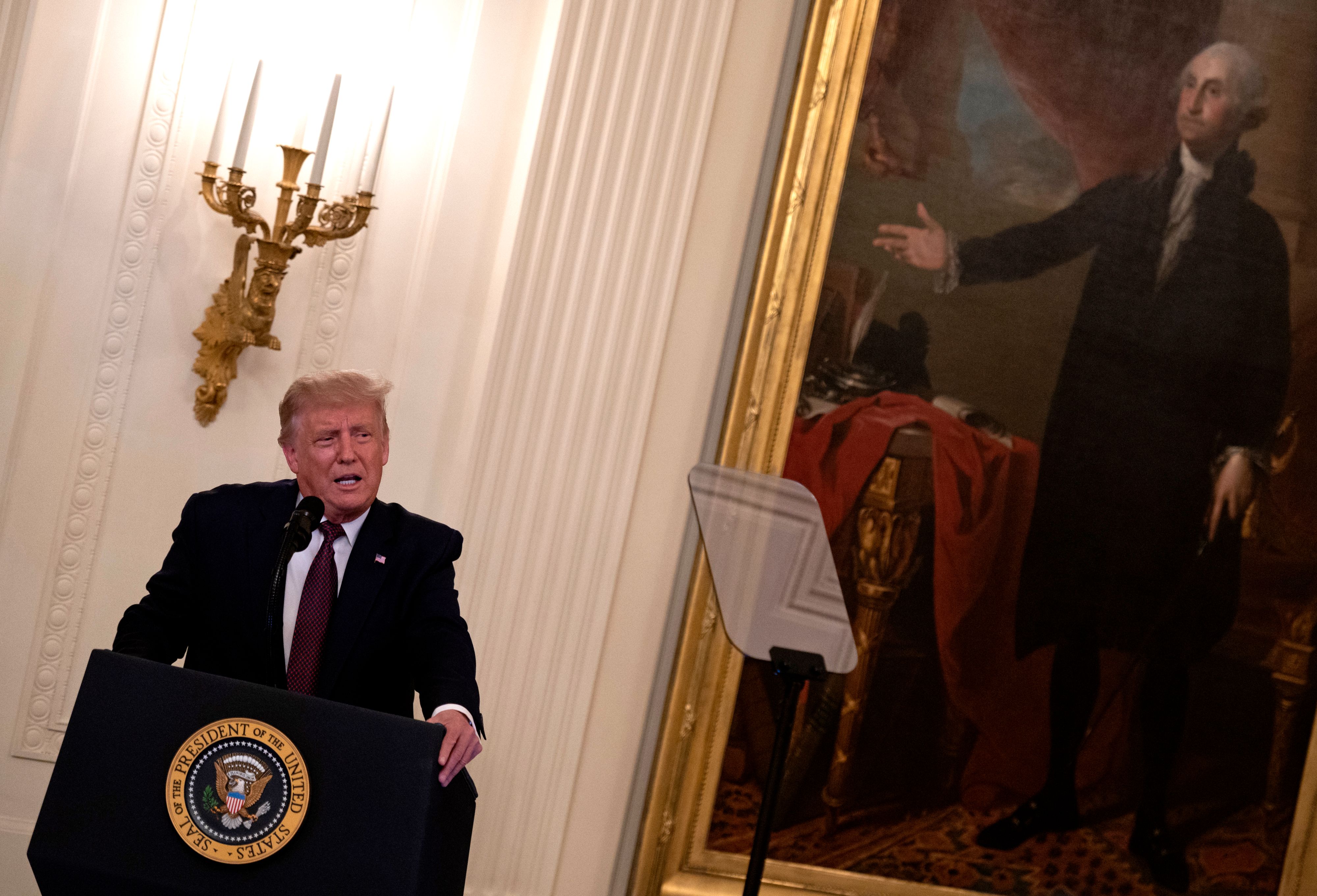 US President Donald Trump speaks before presenting the Medal of Honor to US Army Sergeant Major Thomas Payne (L), for conspicuous gallantry while serving in Iraq, in a ceremony in the East Room of the White House . 8PT2GB.jpg