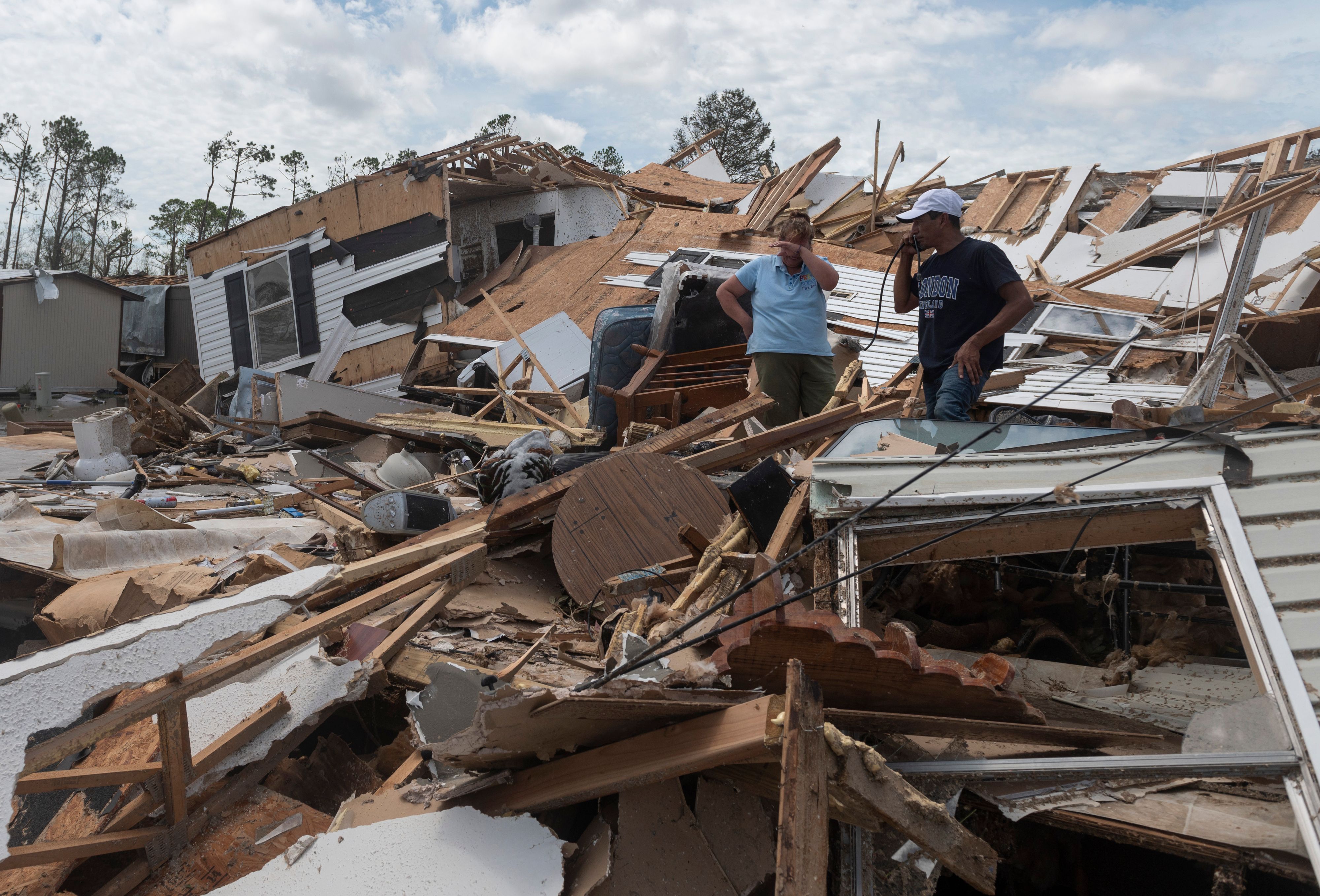 A couple react as they go through their destroyed mobile home following the passing of hurricane Laura in Lake Charles, Louisiana, on August 27, 2020. 1WT1S0.jpg