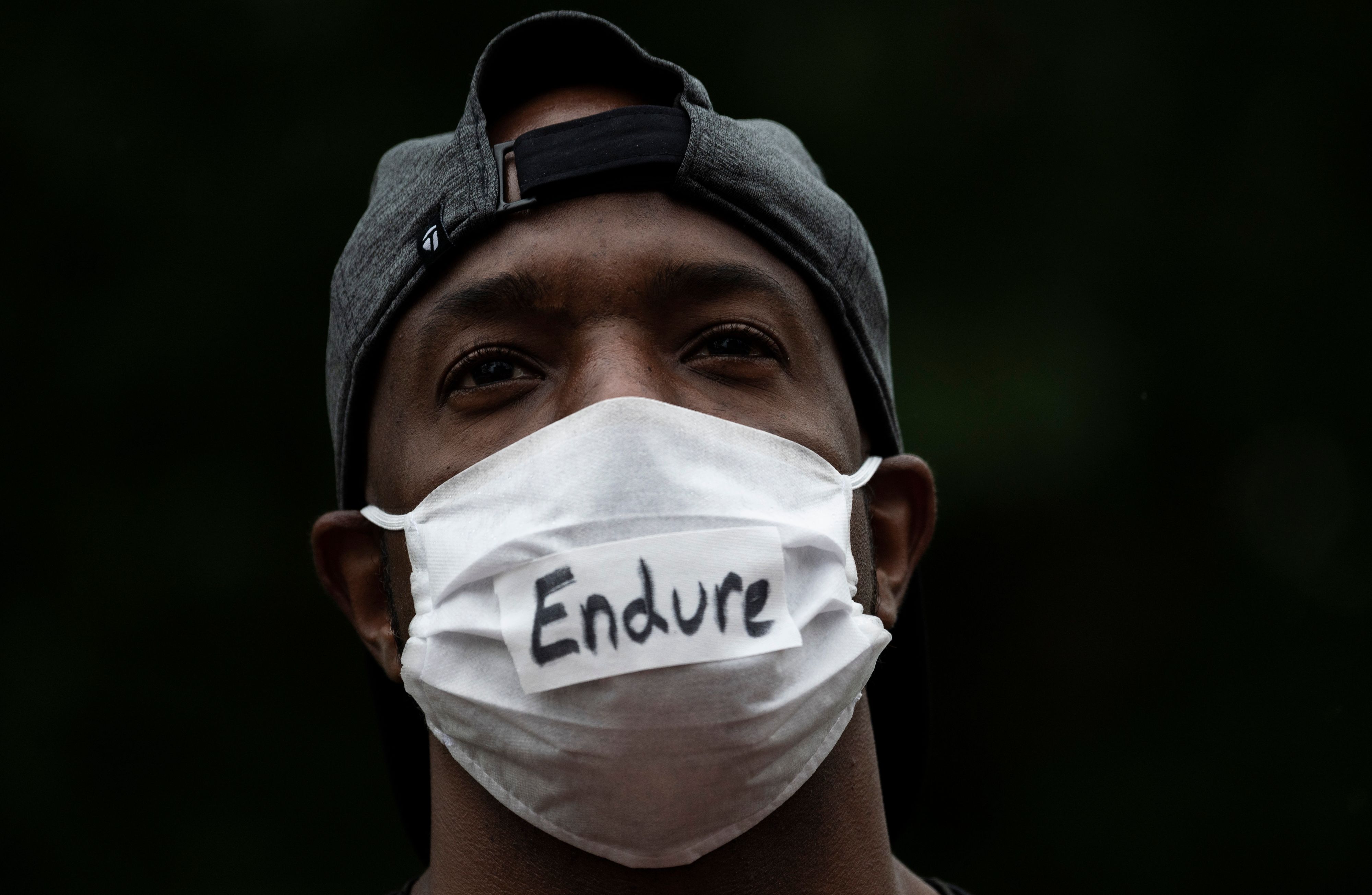 A man wears a message on his mask as he holds a silent prayer for victims of the 1921 Tulsa Massacre on the 100 year anniversary in Tulsa, Oklahoma, on May 31, 2021. 9B64T3.jpg