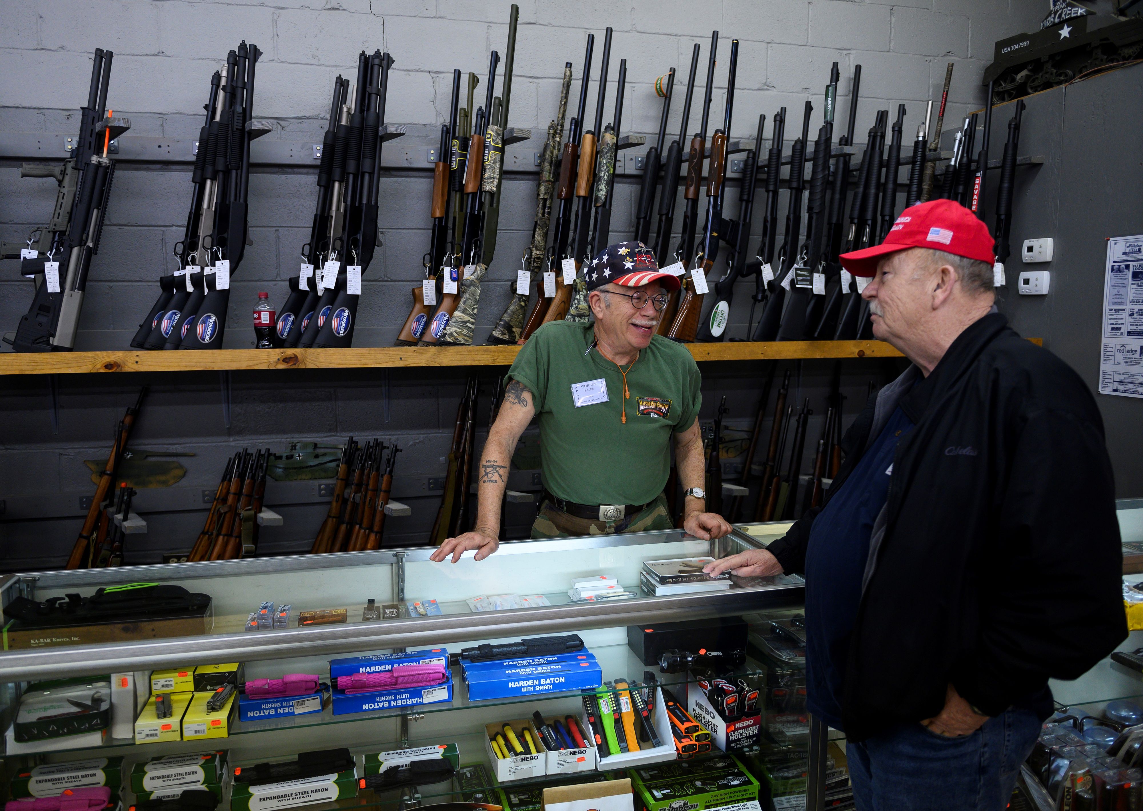 An employee speaks with a customer inside the Knob Creek gun shop at the Knob Creek Machine Gun Shoot and Military Gun show in Bullitt County 1FM8CG.jpg