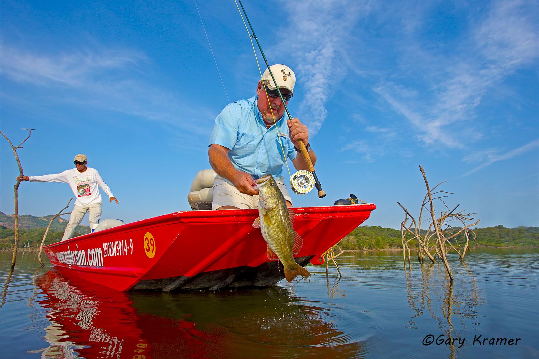 Flyfisherman landing a Largemouth Bass - NFBlf#235d