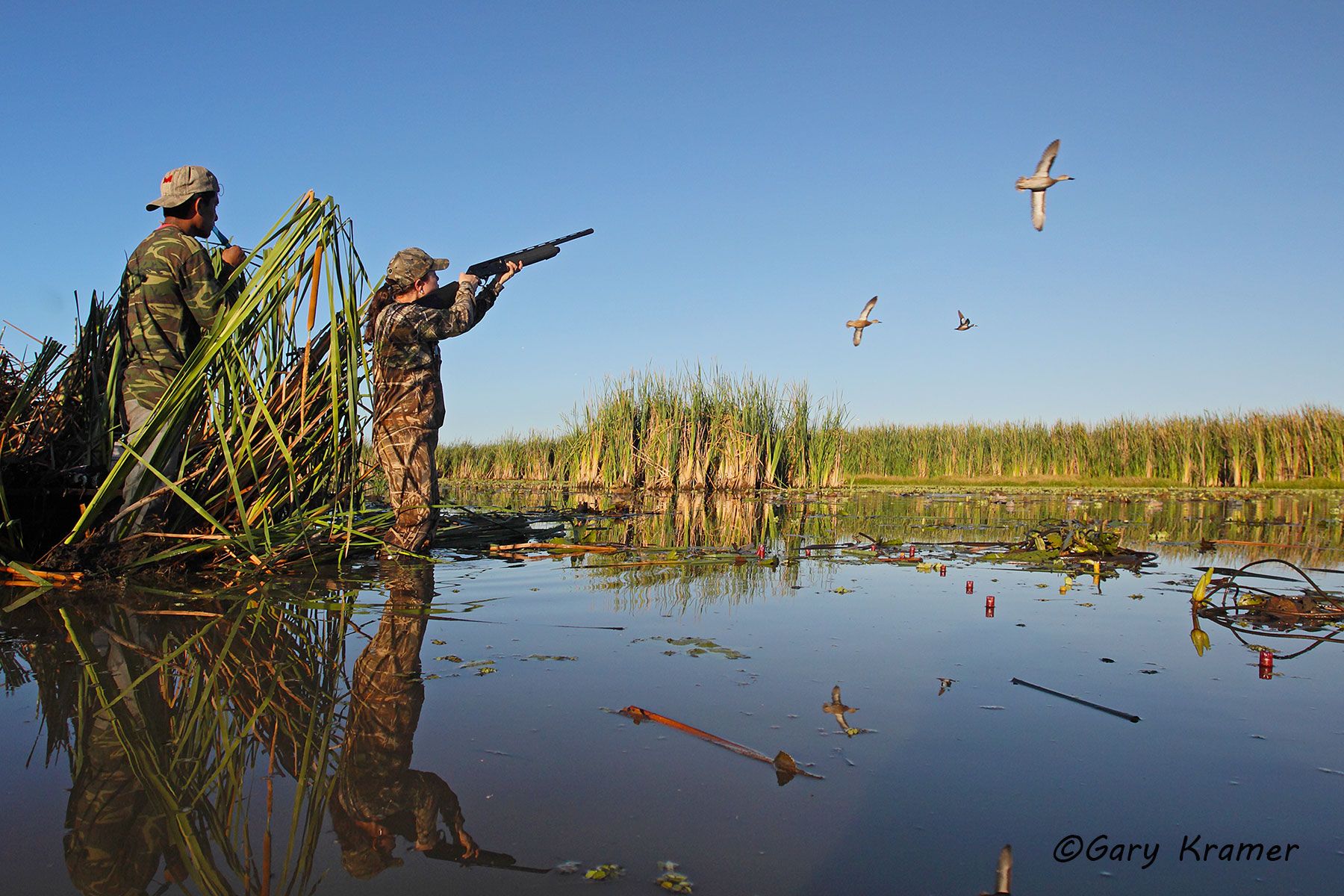 Hunter shooting ar ducks over decoys w/bird boy calling, Nicaragua Hunter shooting at ducks over decoys w/bird boy calling, Nicaragua - CMHhd#003d.jpg