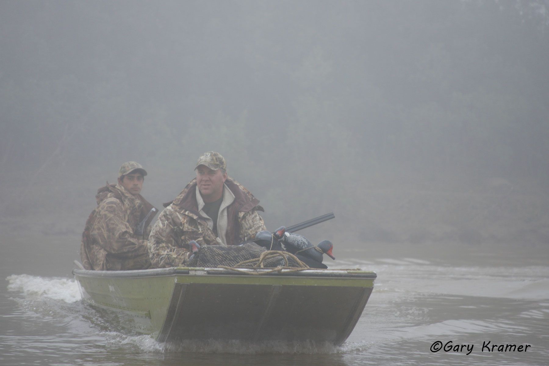 Duck hunter/guide in boat, Argentina - SHDba#025d