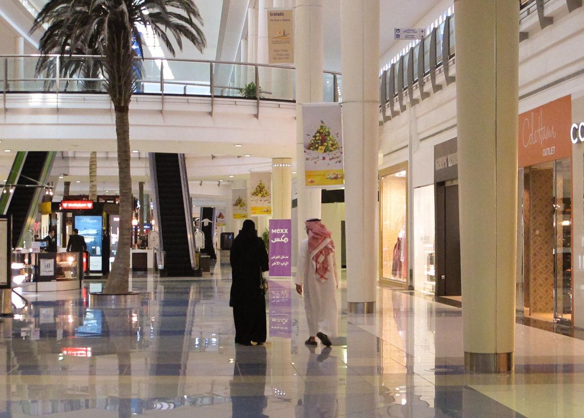 Muslim couple in newly constructed shopping mall in Middle East.