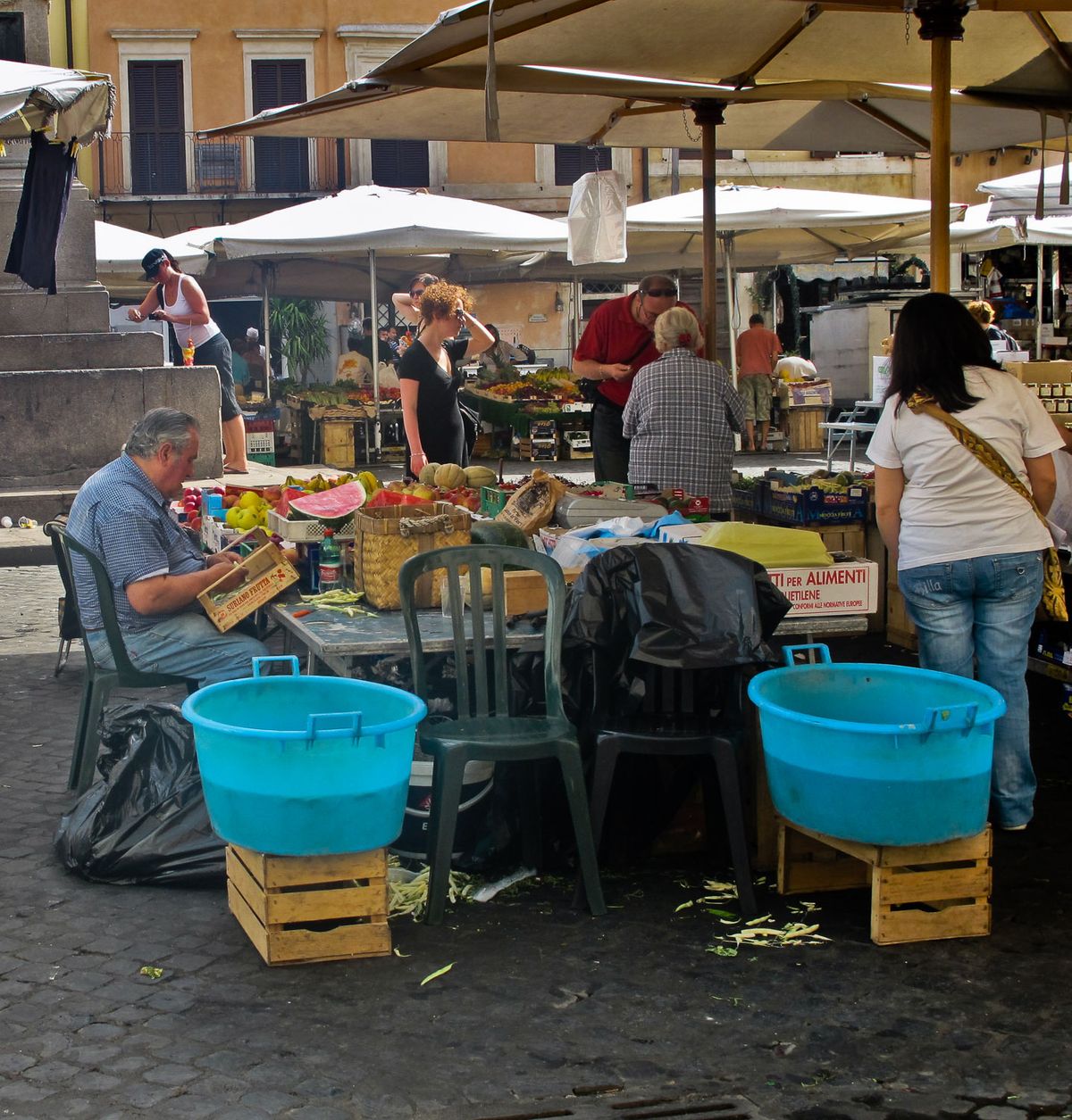 Activity at daily market in public square.