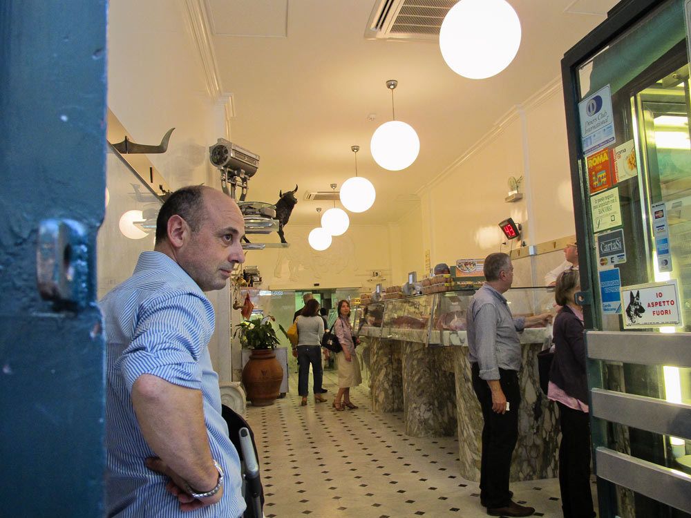 Owner of butcher shop looking outside.