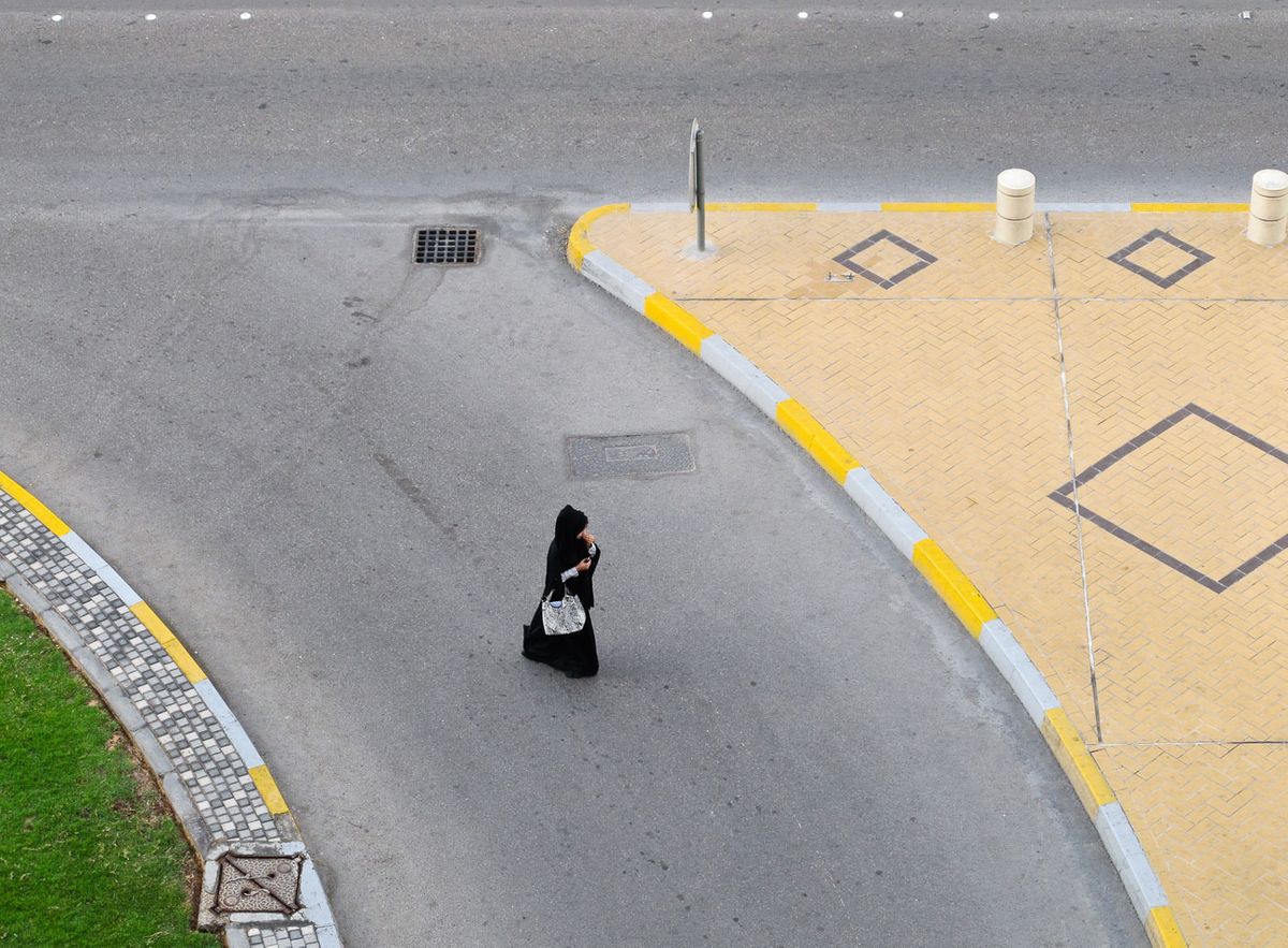 Muslim woman crossing street