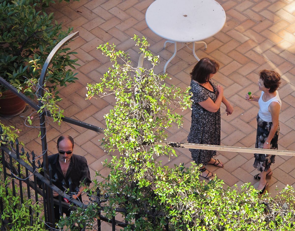 Roman smoking on rooftop.