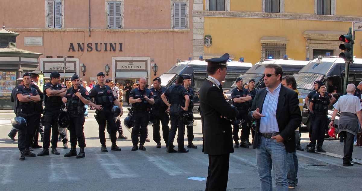 Man discussing issues with police chief on Roman street.