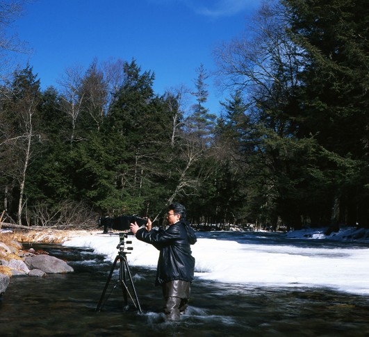 Photographer works with a Linhoff 4x5 view film camera Robert Hsu works in the icy Winter stream.jpg