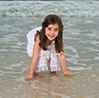 Image of girl playing along seashore