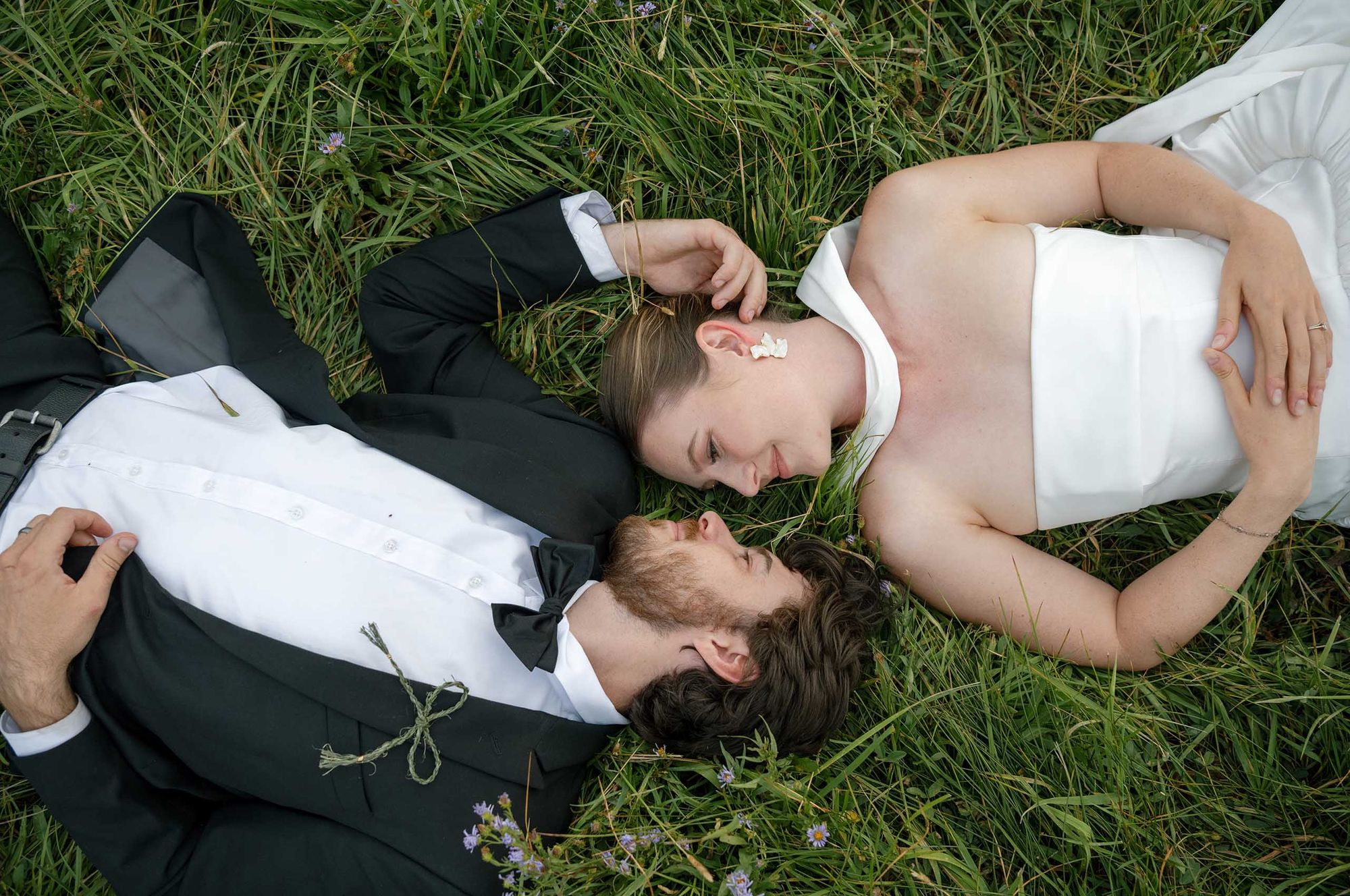 Couple laying in a meadow for wedding portraits. Central Oregon elopement photos