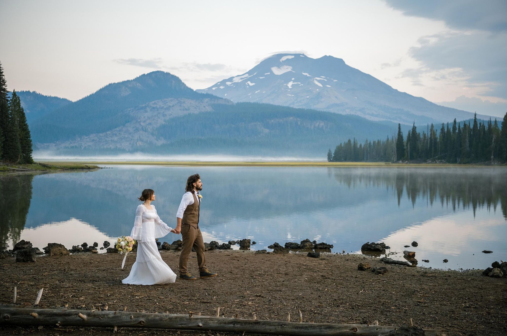 Couple walks hand in hand at Sparks Lake Sunrise elopement at Sparks Lake