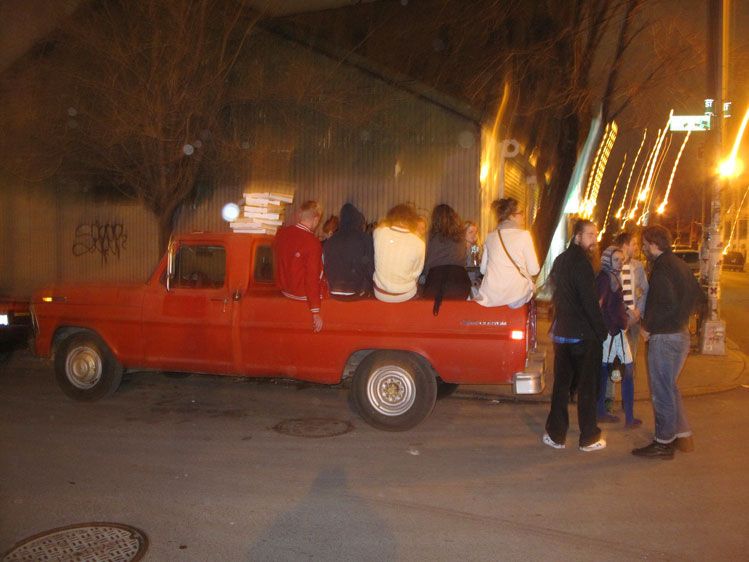 Eating pizza outside of Roberta's in the back of a truck, since the restaurant was full.