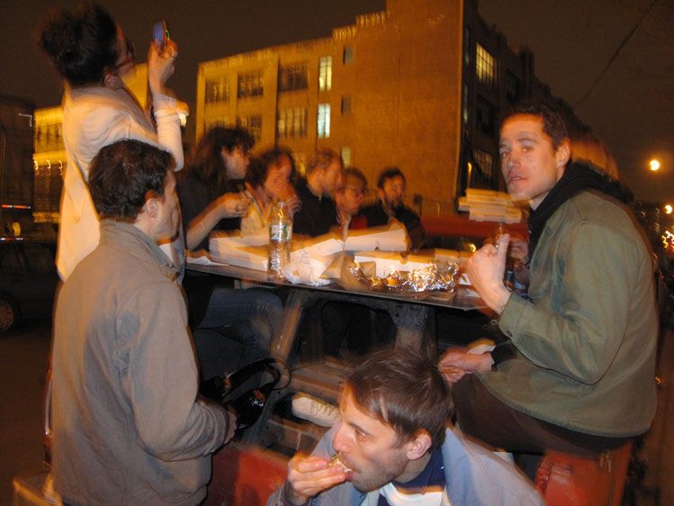 Eating pizza outside of Roberta's in the back of a truck since the restaurant was jamming' full.