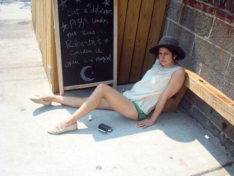 A cook on a cigarette break oputside of Roberta's Pizzeria