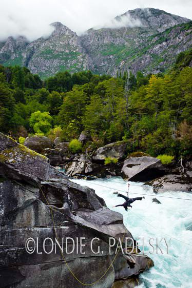 Women does the upside down splits on the Tyrolean Traverse above Zeta Rapid, Cave Camp, Futalefu River, Los Lagos Region, Patagonia, Chile, South America ©Londie G. Padelsky 11SAC_LGP3667_LondieGPadelsky