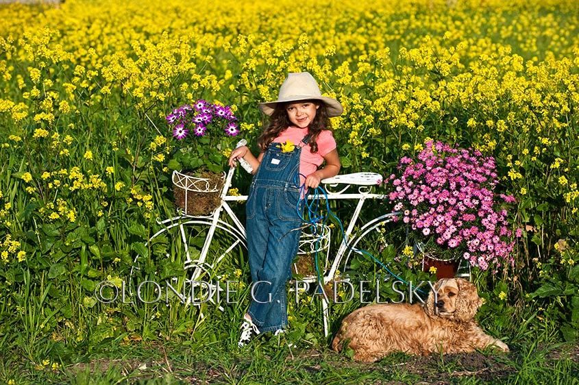 Photo of young girl with dog in flowers_LGP-6269_LondieGPadelsky